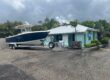 Manatee Pocket Yacht Sales Office with a boat parked in front